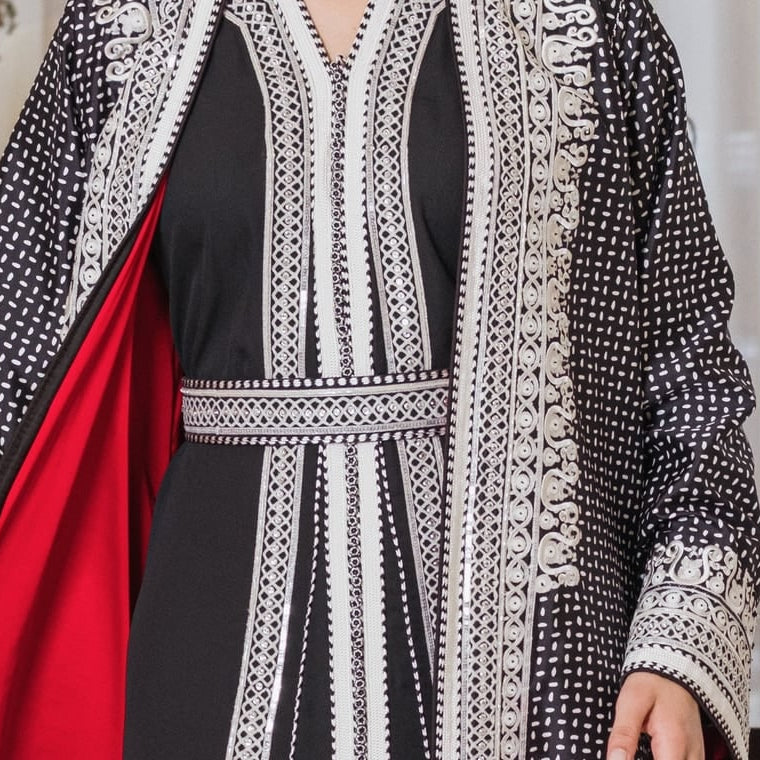 Black and white embroidered Moroccan kimono set worn over a red lining