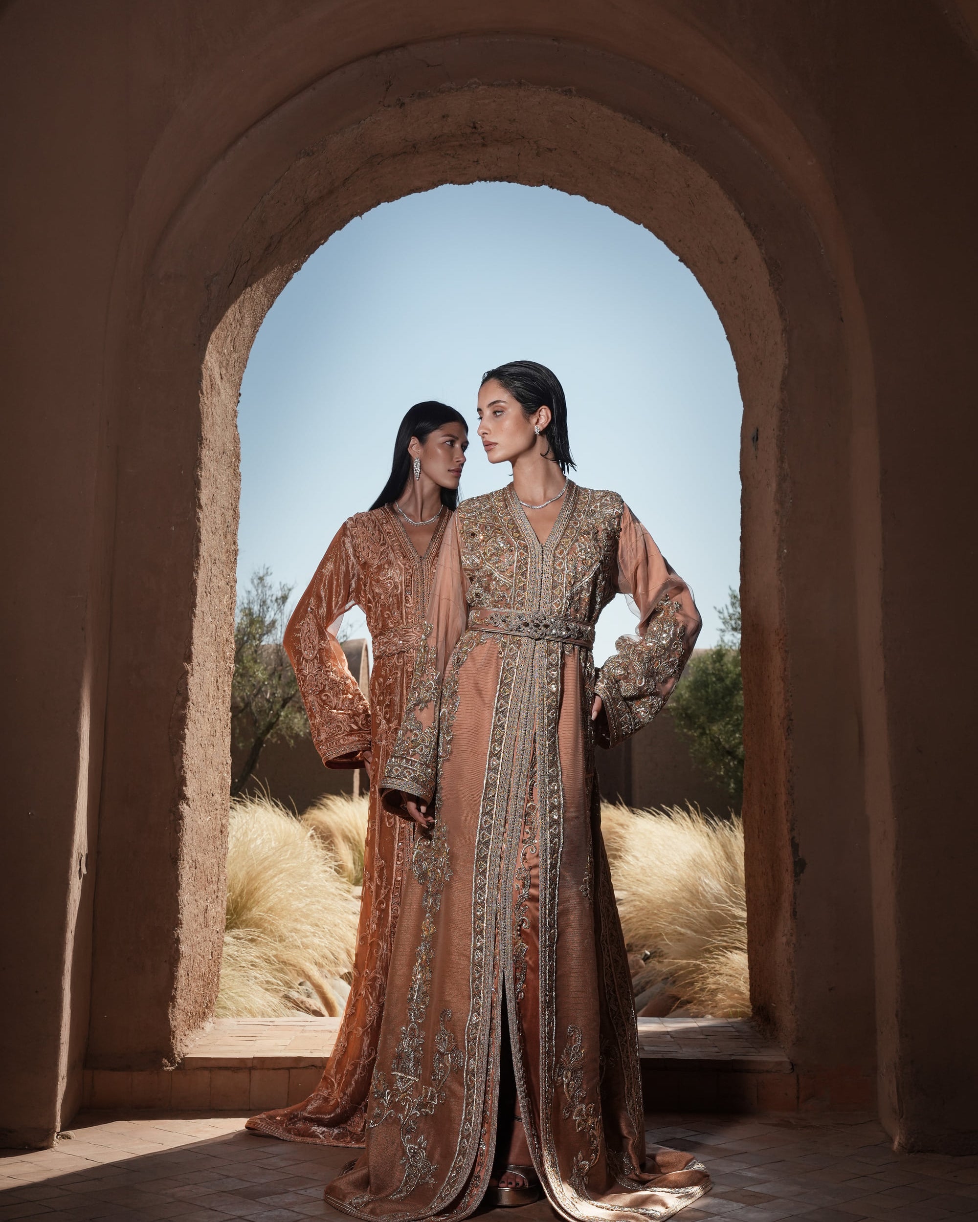 Copper Solstice devoré copper velvet Moroccan kaftan with tone-on-tone embroidery, shown alongside a second look