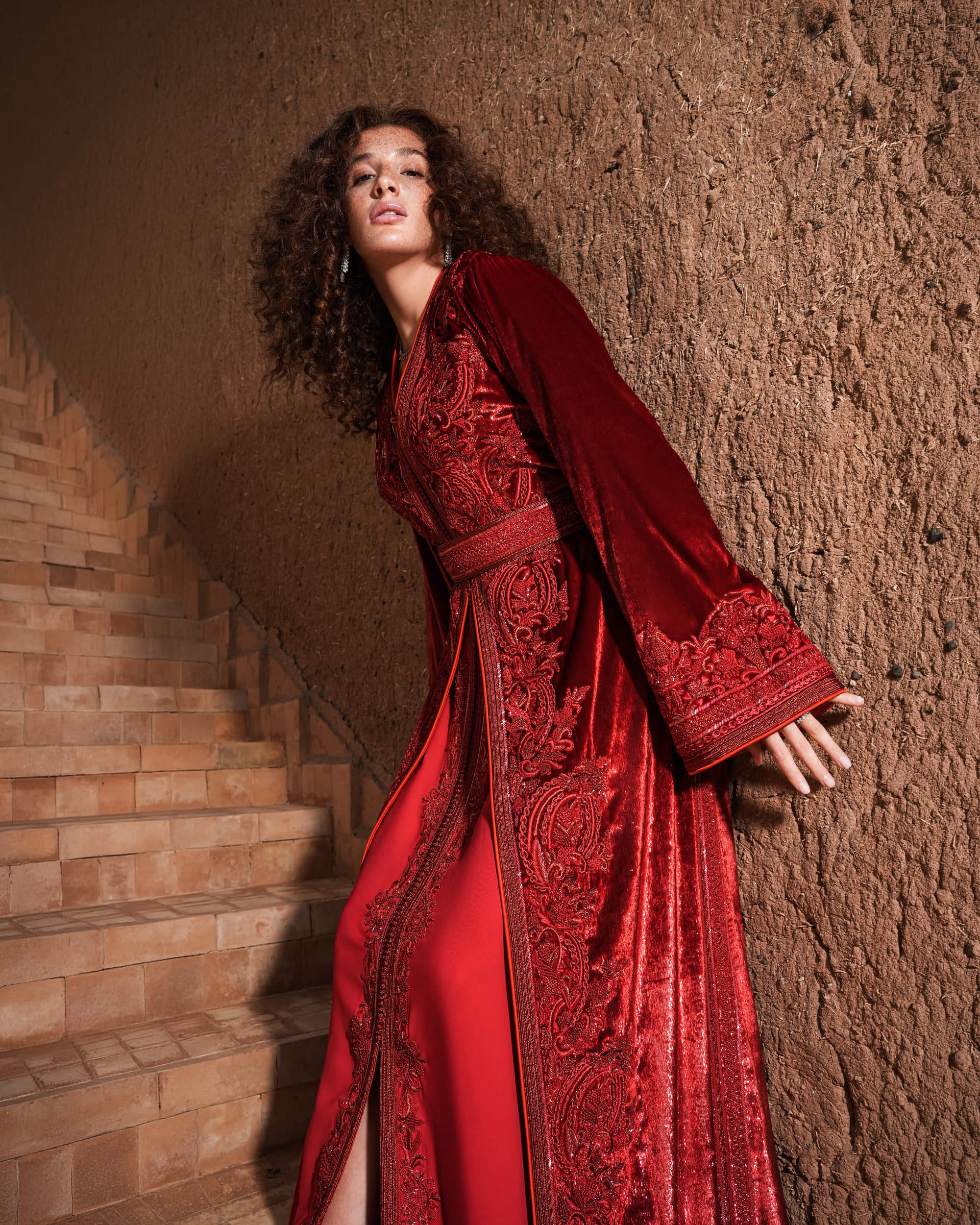 Garnet Adagio burgundy velvet Moroccan kaftan with tone-on-tone embroidery, matching belt and wide sleeves, full-length view