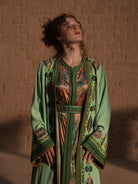 Anise Pavilion anise green Moroccan kaftan with Berber braid trims over a printed dress