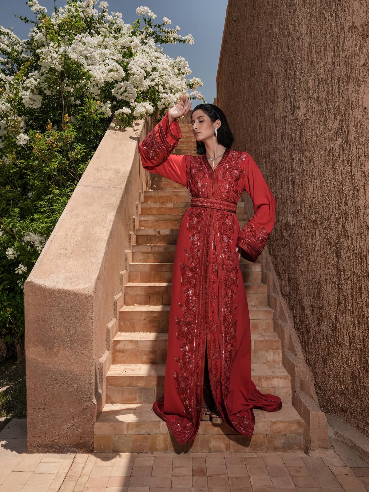 Carmine Cadence red Moroccan kaftan under white blossom