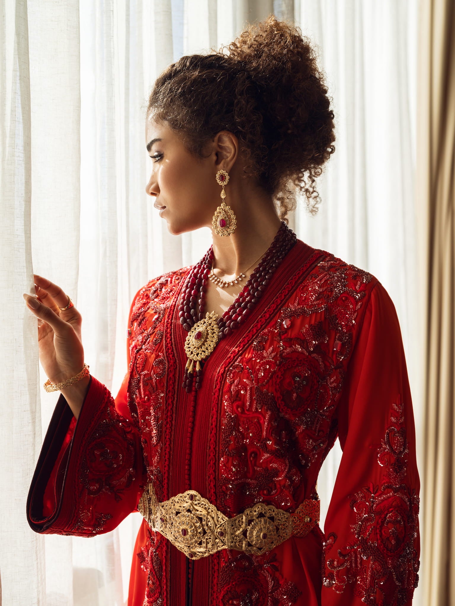 Deep ruby red couture Moroccan kaftan with gold embroidery and belt, front view
